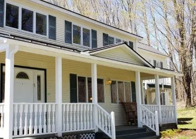 Yellow Victorian farmhouse in Middlebury VT with seamless gutters